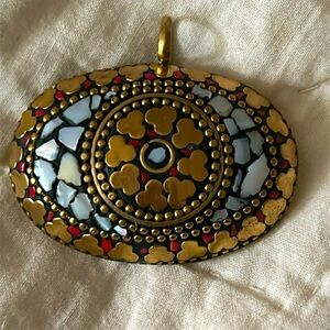 Vintage brass necklace pendant with inlaid red coral and mother of pearl.